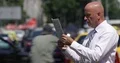 Businessman Reading Newspaper City Busy Street Cars Passing Traffic Man Standing 4k or 4k+ Resolution