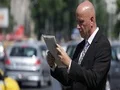 Businessman Reading Newspaper City Busy Street Cars Passing Traffic Man Standing 4k or 4k+ Resolution