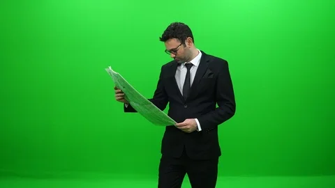 Businessman Reading Newspaper in Front of Green Screen Stock Footage 88651753