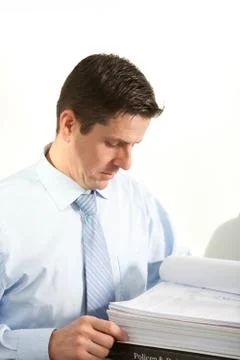 Businessman reading notes in a large binder Foto stock