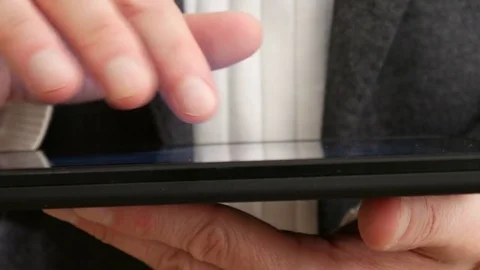 Businessman reading on tablet computer 4 K Video stock 71361298