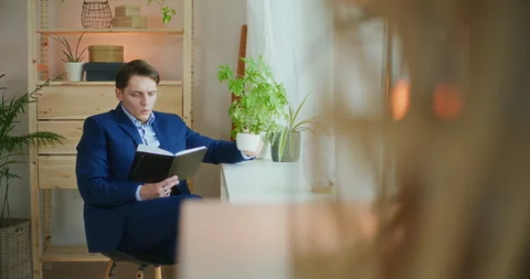 Businessman Reads While Drinking Coffee Stock Footage 276336513