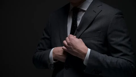 Businessman receiving a bundle of cash and putting it in his pocket in the dark Stock Footage 336765833