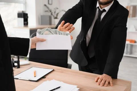 Businessman refusing bribe money in envelope, anti-corruption and ethical bus Stock Photos