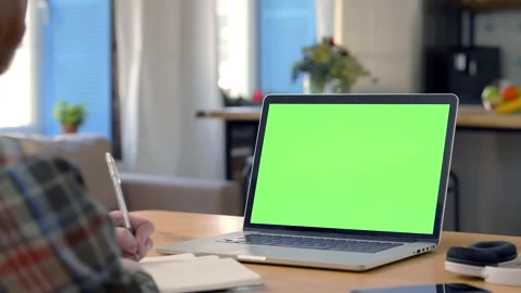 Businessman remote working or studying sitting at kitchen table using laptop Stock Footage 165721996