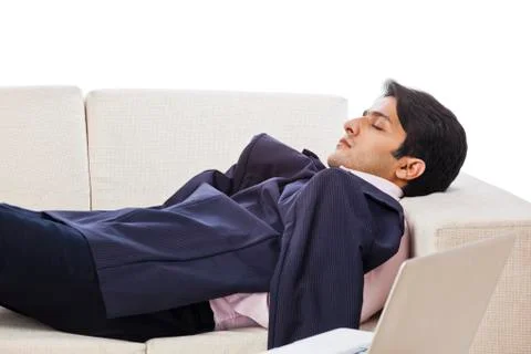 Businessman resting on a couch Stock Photos