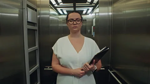 A businessman rides in an elevator with ... | Stock Video | Pond5