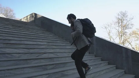 Businessman run on the stairs Stock Footage