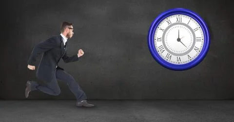 Businessman running while looking at clock Foto stock