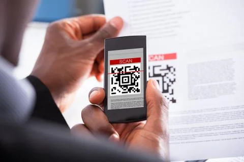 Businessman scanning qr code Stock Photos