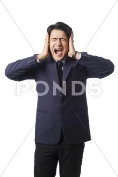 Businessman screaming with hands over his ears Stock Photos
