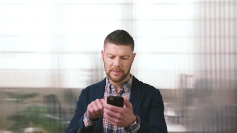 Businessman, scroll and text message in office with phone, email and website for Stock Footage 334537592