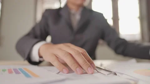 A businessman is seriously stressed out at their desk and crunches the paper. Stock Footage 147956853