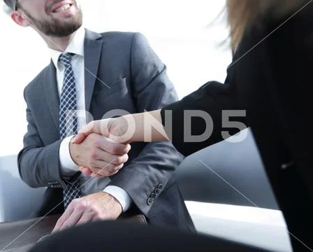 Businessman shaking hands to seal a deal with his partner Stock Photos