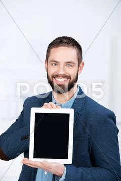 Businessman showing digital tablet in office Stock Photos