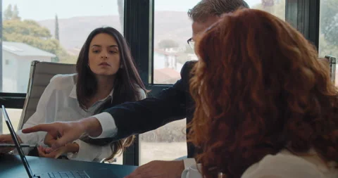 A businessman showing a new project on a computer to the rest of the team Stock Footage 139919333