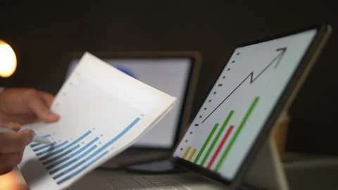 Businessman showing trend data column graph on the screen and the papaer. Stock Footage 168325692