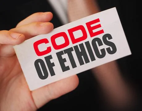Businessman shows a card with text Code of ethics 写真素材