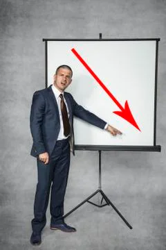 Businessman shows a decrease in trading Stock Photos