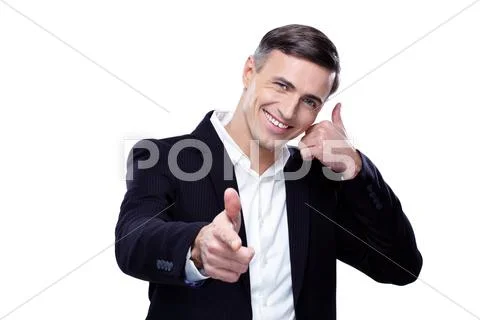 Businessman shows 'phone me' gesture and point towards camera Stock Photos