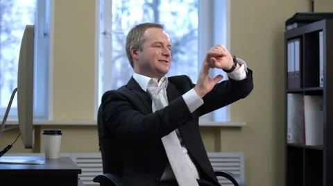 Businessman shutdown your computer and uses a smart watch, spinning in a chair. Stock Footage 60232957