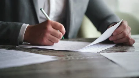 Businessman signing contract during meeting with business colleague in cafe Stock Footage