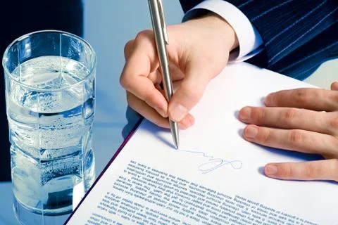 Businessman signing a contract Stock Photos