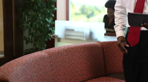 Businessman sits down and read digital tablet 動画素材 35872646