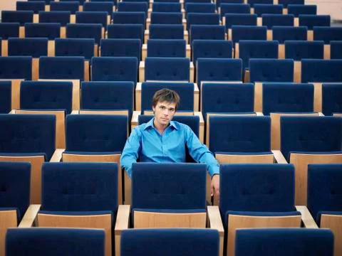 Businessman Sitting Alone On In Auditorium Stock Photos