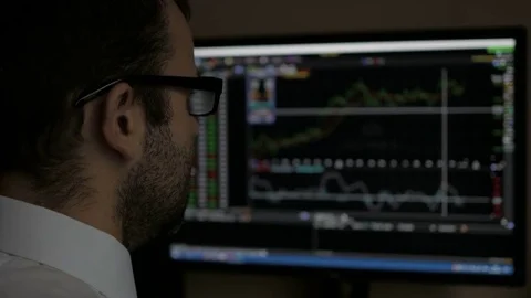 Businessman sitting and using computer showing trading graph stock exchange t Stock Footage 83705938