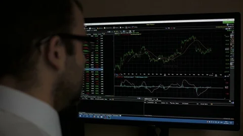 Businessman sitting and using computer showing trading graph stock exchange t Stock Footage 84137668
