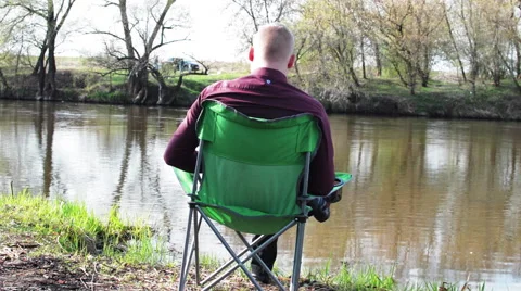 Businessman Sitting by Back With a Tablet and is Forced to Work For Camping by Stock Footage 62776867