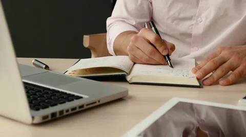 Businessman sitting in cafe with laptop, using tablet pc and mobile phone Stock Footage 55654018