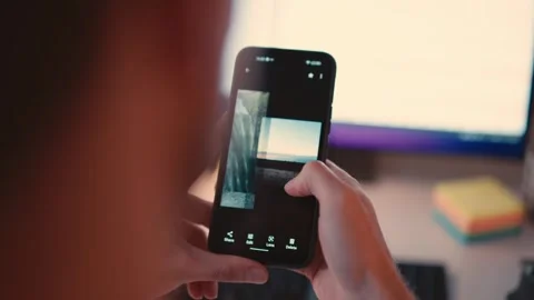 Businessman Sitting at Computer and Checking Smartphone Stock Footage 307762868