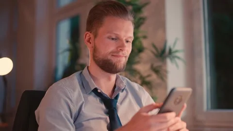 Businessman Sitting at Computer and Checking Smartphone Vídeo Stock 307762938