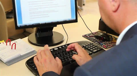 Businessman sitting at the computer in the office. View from the back. Stock Footage 24857001