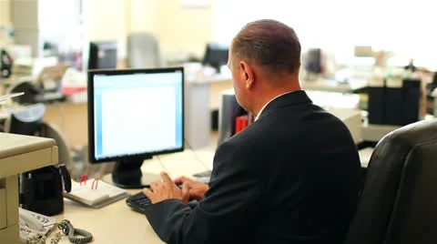 Businessman sitting at the computer in the office. View from the back. Video stock 24857409