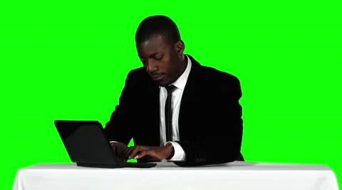 Businessman sitting at a desk and using laptop. Office work. Green screen Stock Footage 62808769