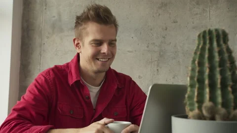Businessman sitting at desk looking at computer screen talking with friend make Stock Footage 141123976