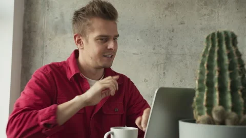 Businessman sitting at desk looking at computer screen talking with friend make Stock Footage 141664237