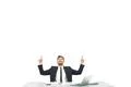 The businessman sitting at the desktop and gesturing on the white background Photo