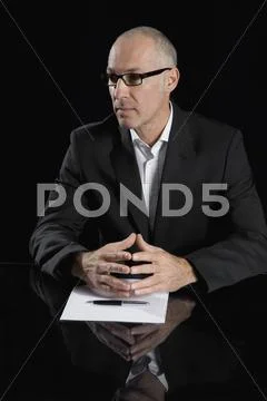 A businessman sitting at a table Stock Photos