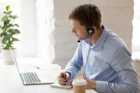 Businessman sitting at workplace improve knowledge using online lessons Stock Photos