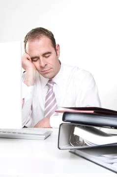 Businessman sleeping at computer Stock Photos