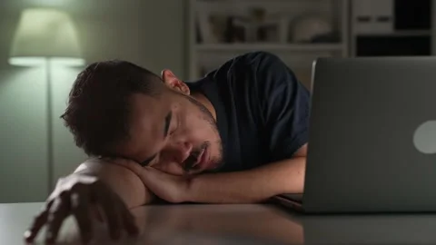 Businessman sleeping while using computer working late at night at home Video stock 167941842