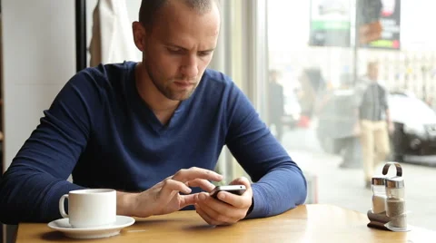 Businessman with smartphone during lunch in cafe Stock Footage