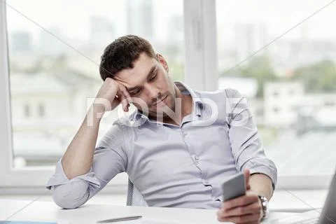 Businessman with smartphone at office Stock Photos