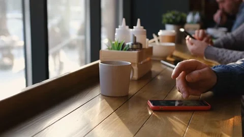 Businessman with smartphone while having lunch in a cafe. Close view of Stock Footage 169778106