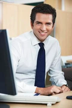 Businessman Smiling At Computer Desk Stock Photos
