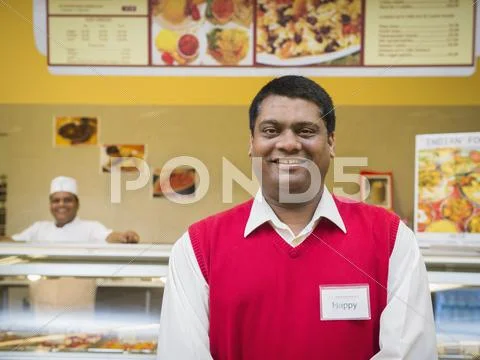 Businessman Smiling By Restaurant Counter